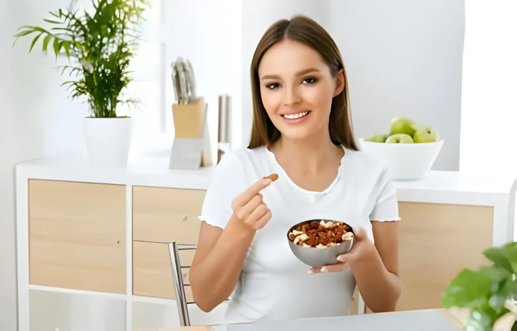 Woman in a white shirt holding a bowl of healthy cereal or granola