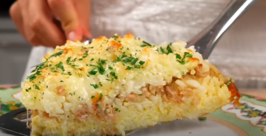 A delicious slice of baked tuna rice with eggs garnished with parsley