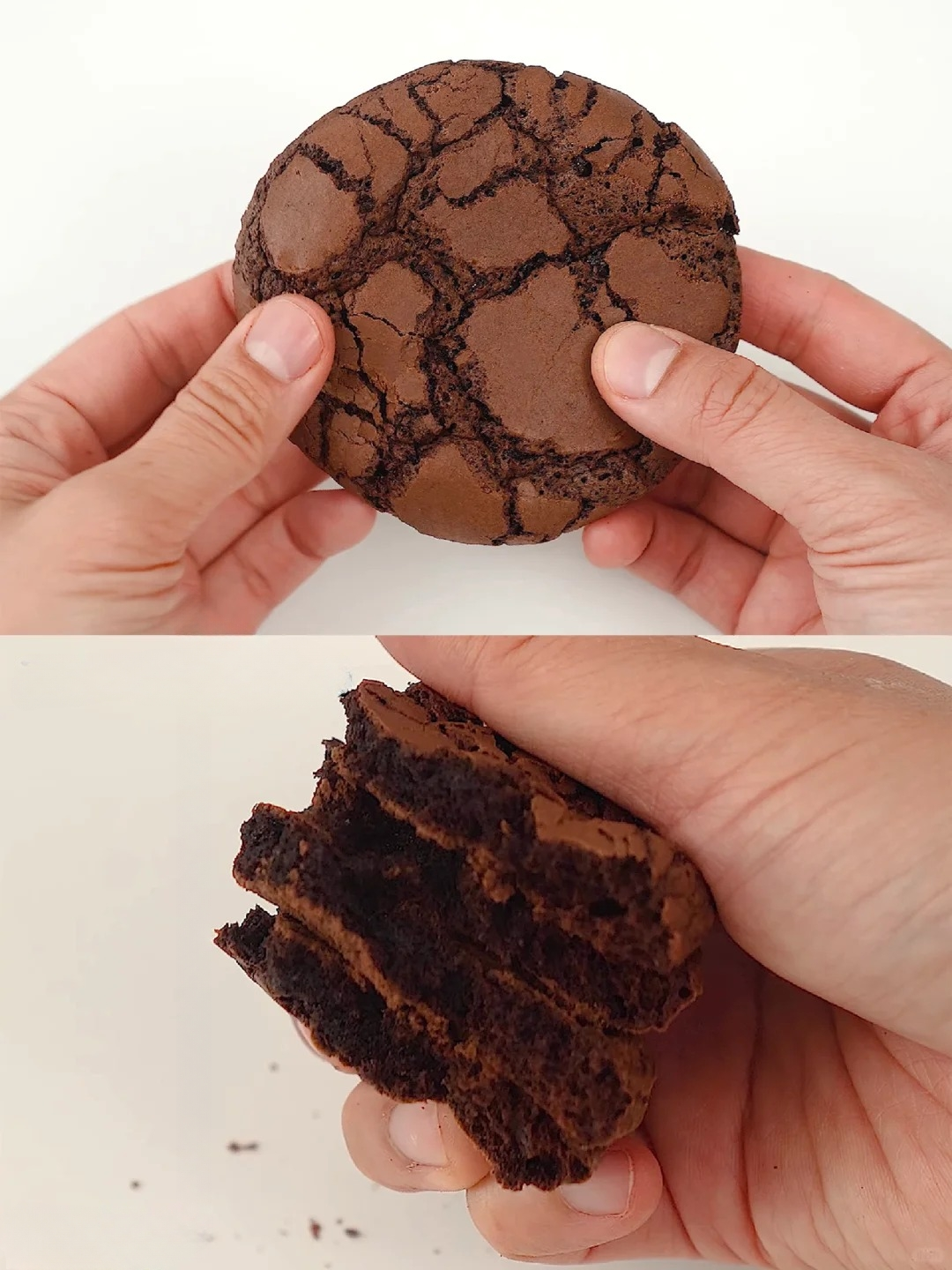 Hand holding a soft and chewy fudge brownie mix cookie with a cracked top texture, another hand showing the inside of the cookie revealing its moist and rich chocolate layers.